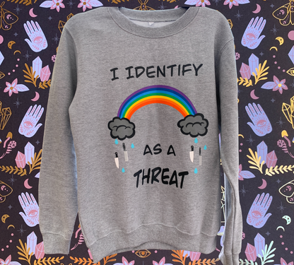 jersey gray crewneck sweater with the words "I identify as a threat" with a rainbow with clouds raining knives