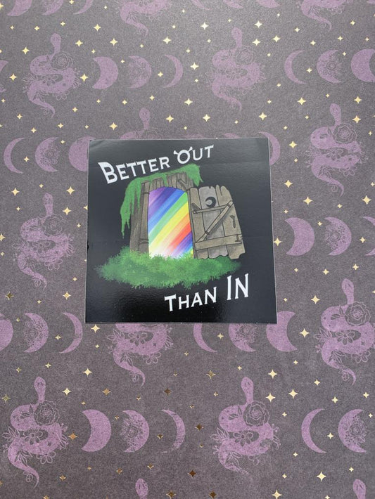 black back ground with and open outhouse door with a rainbow on the inside with the words "better out than in"