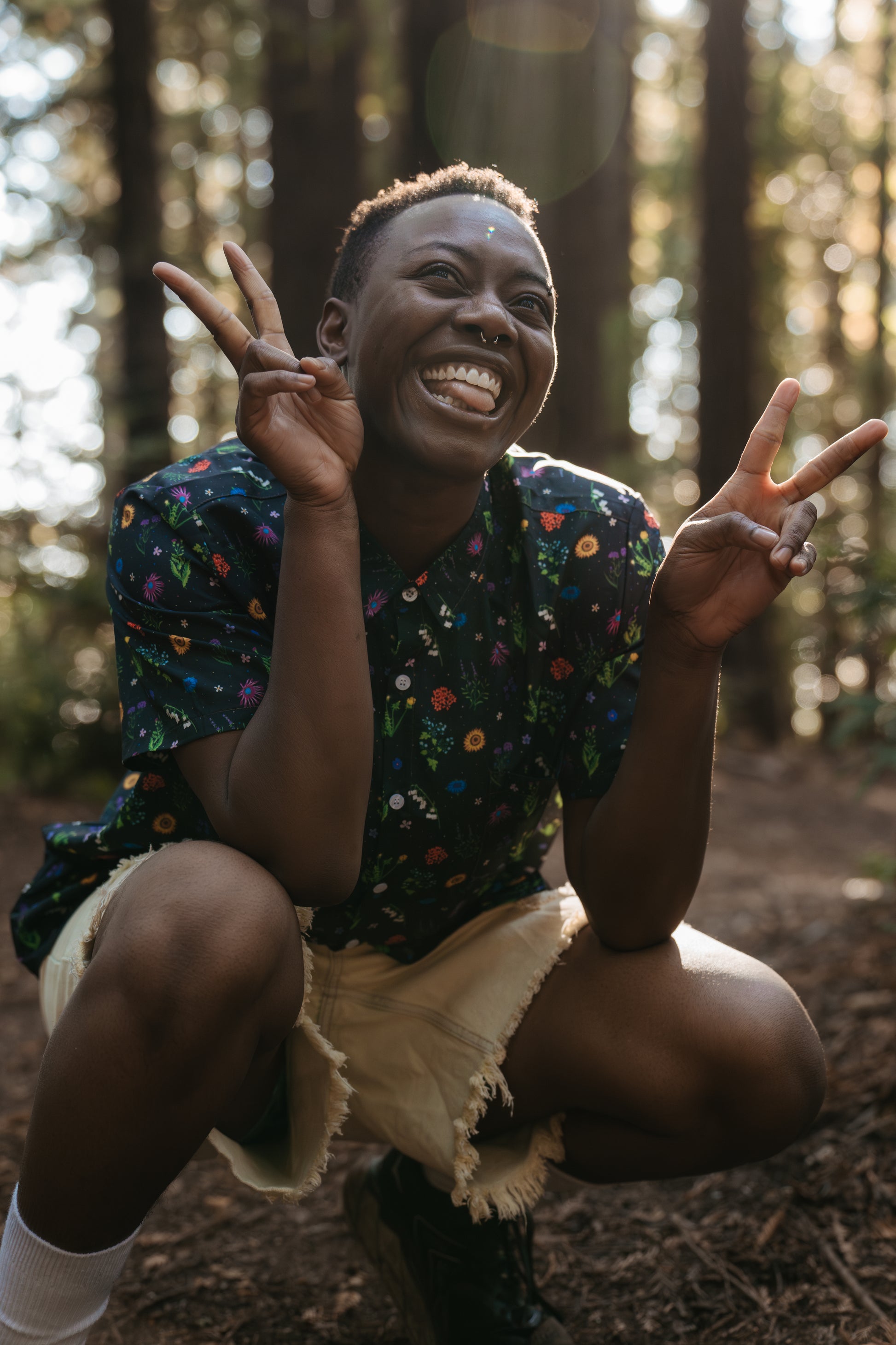 G smiling and throwing peace signs in florally yours button-up